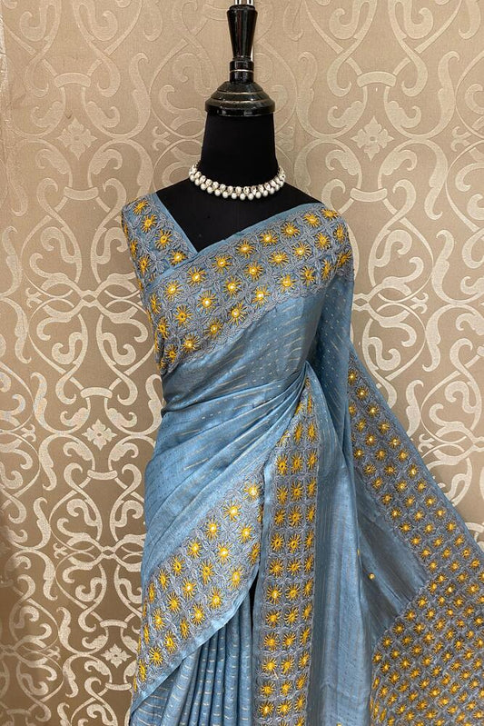 Light blue Tussar Lambani and Kutch work saree with stitched blouse from Saarang Sarees, showcasing traditional craftsmanship and intricate designs.
