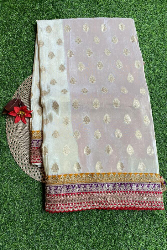 Off-White Gold Tissue Khaddi saree with embroidered border and unstiched blouse from Saarang Sarees, traditional wear for special occasions.