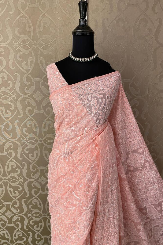 Peach cotton Chikankari saree with unstiched blouse, ideal for party wear, by Saarang Sarees, showcasing intricate embroidery.