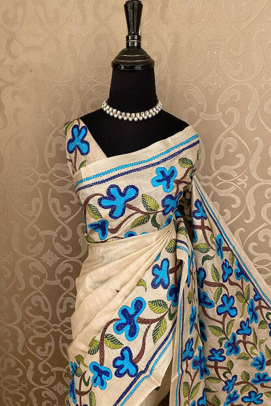 Beige Tussar embroidery saree with kantha work border and unstitched blouse from Saarang Sarees, traditional Indian attire.