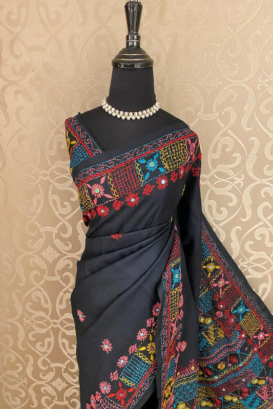 Black Tussar saree with Lambani embroidery and unstitched blouse from Saarang Sarees, featuring traditional design and intricate work.