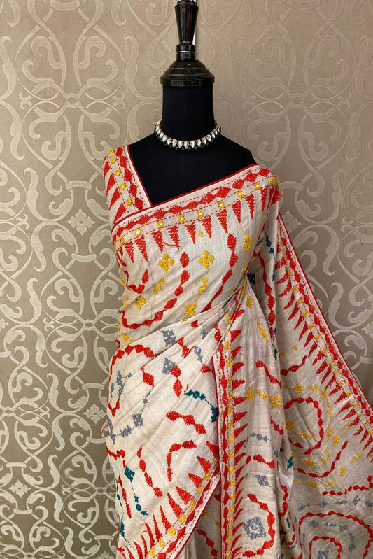 Beige Tussar Lambani and Kutch work saree with stitched blouse, traditional wear by Saarang Sarees, showcasing intricate embroidery and fabric.