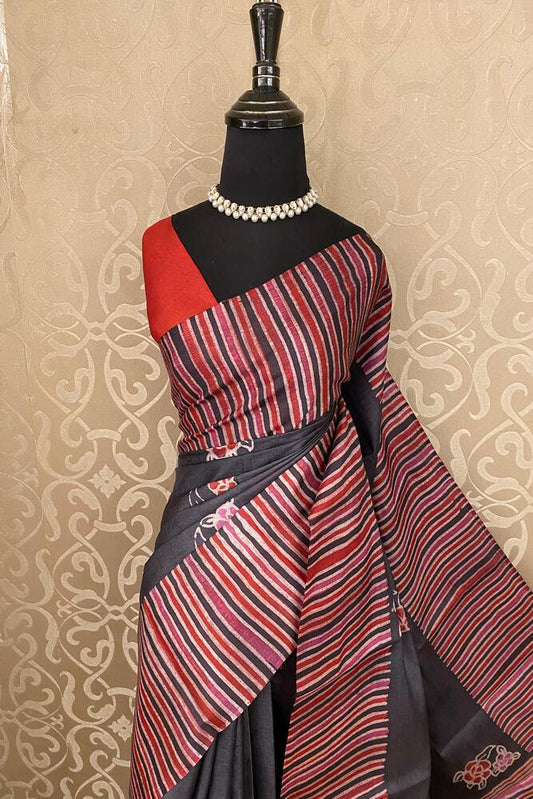 Black Tussar Silk printed saree with unstiched blouse, traditional wear by Saarang Sarees, shown draped and styled on a mannequin.
