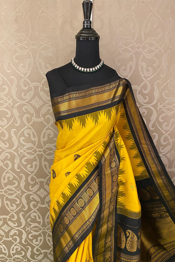 Yellow Gadwal silk saree with traditional gold zari work and matching unstiched blouse from Saarang Sarees.