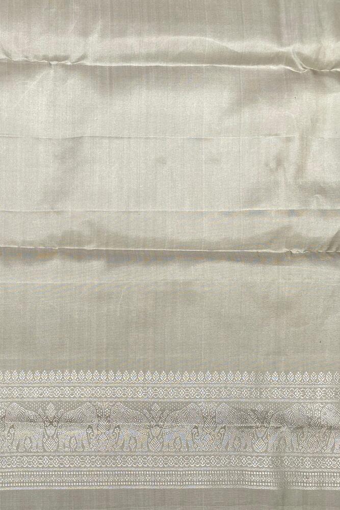 Beige pure Kanjeevaram silk saree with traditional design and matching unstiched blouse from Saarang Sarees.