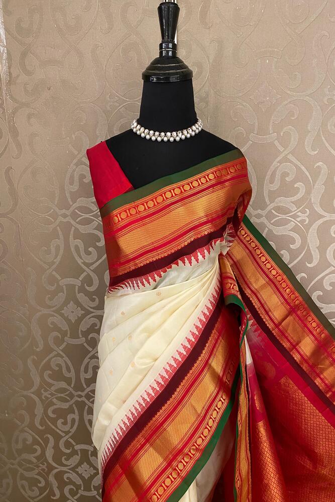 Traditional Off-White Gadwal Silk Saree with intricate gold zari work and an unstitched blouse from Saarang Sarees.