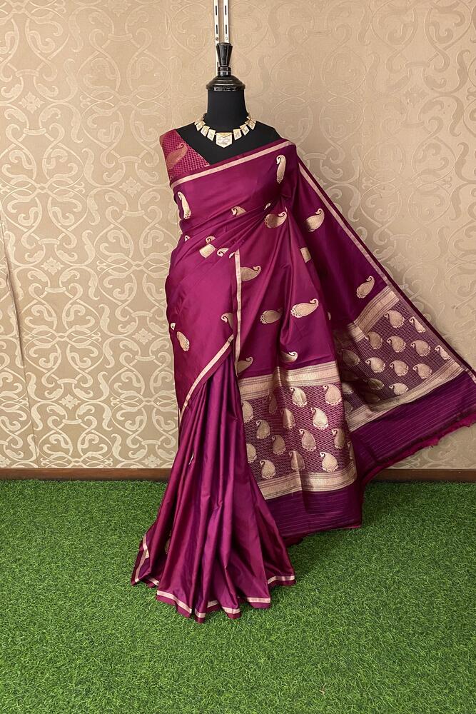 Deep purple Katan Mashru silk Banarasi saree with intricate gold zari work, displayed with an unstiched matching blouse.