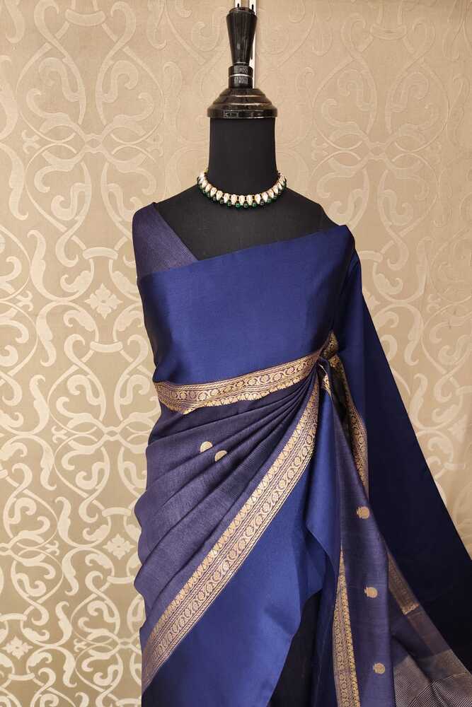 Navy blue Tussar Banarasi silk saree from Saarang Sarees with hand-woven motifs and an unstiched blouse for traditional wear.