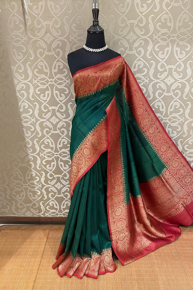 Forest green Tussar Banarasi silk saree with hand-woven motifs and unstiched blouse, traditional wear by Saarang Sarees.