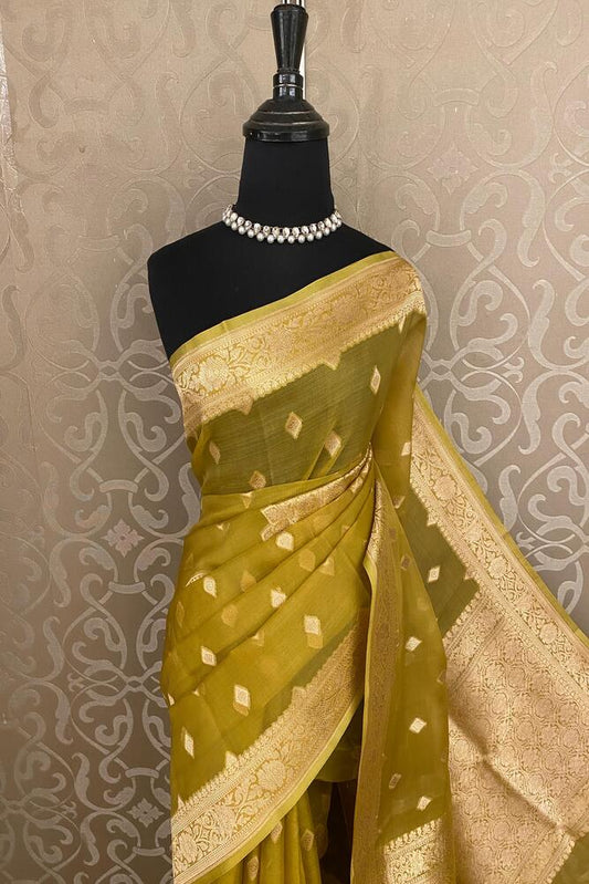 Dusty yellow Kora Banarasi silk saree with handwoven work and unstiched blouse, traditional wear by Saarang Sarees.