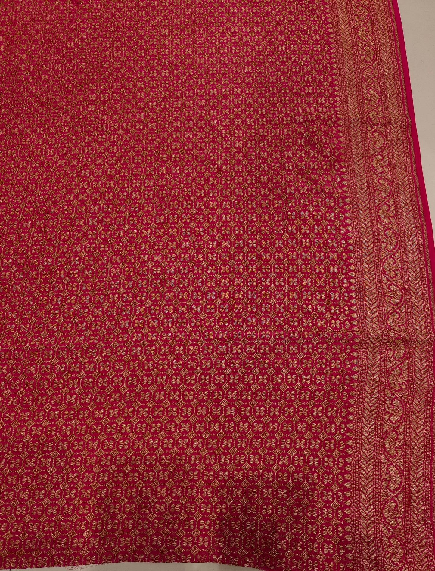 Rani crepe Khaddi Banarasi silk saree with intricate gold zari work and matching unstiched blouse, traditional Indian attire by Saarang Sarees.