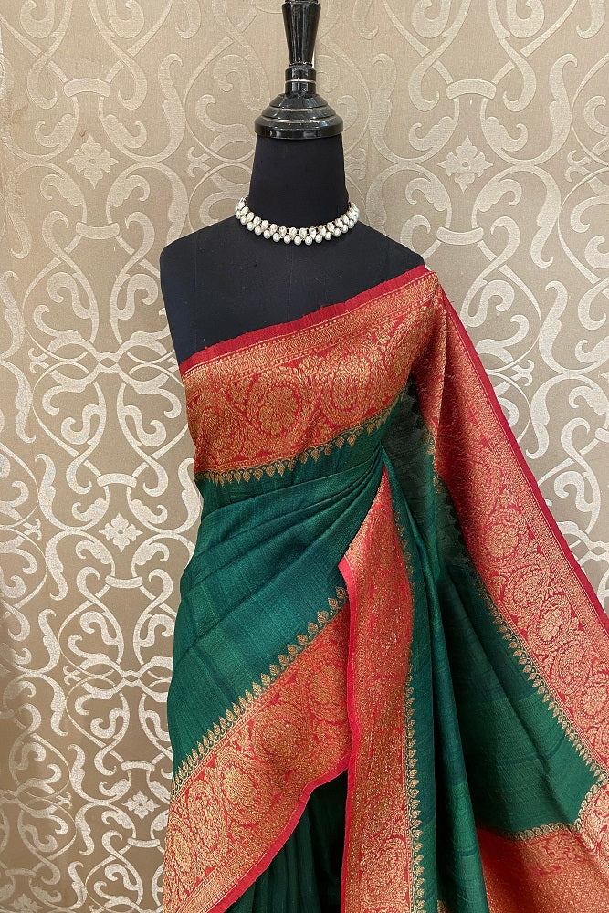 Forest green Tussar Banarasi silk saree with handwoven motifs and matching unstiched blouse, traditional wear by Saarang Sarees.