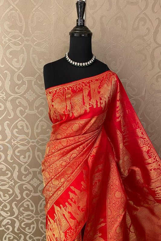 Red pure Kanjeevaram silk saree from Saarang Sarees with intricate traditional design and matching unstiched blouse.