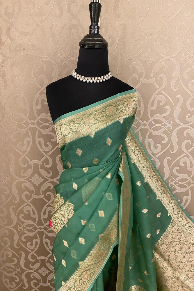 Green Kora Banarasi silk saree with intricate handwoven work and unstiched blouse, traditional wear by Saarang Sarees.
