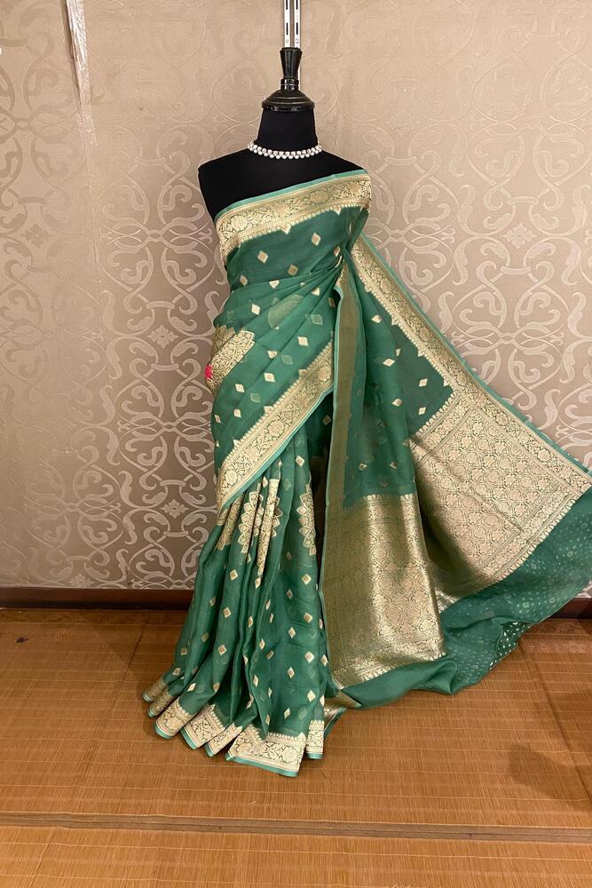 Green Kora Banarasi silk saree with intricate handwoven work and unstiched blouse, traditional Indian wear by Saarang Sarees.