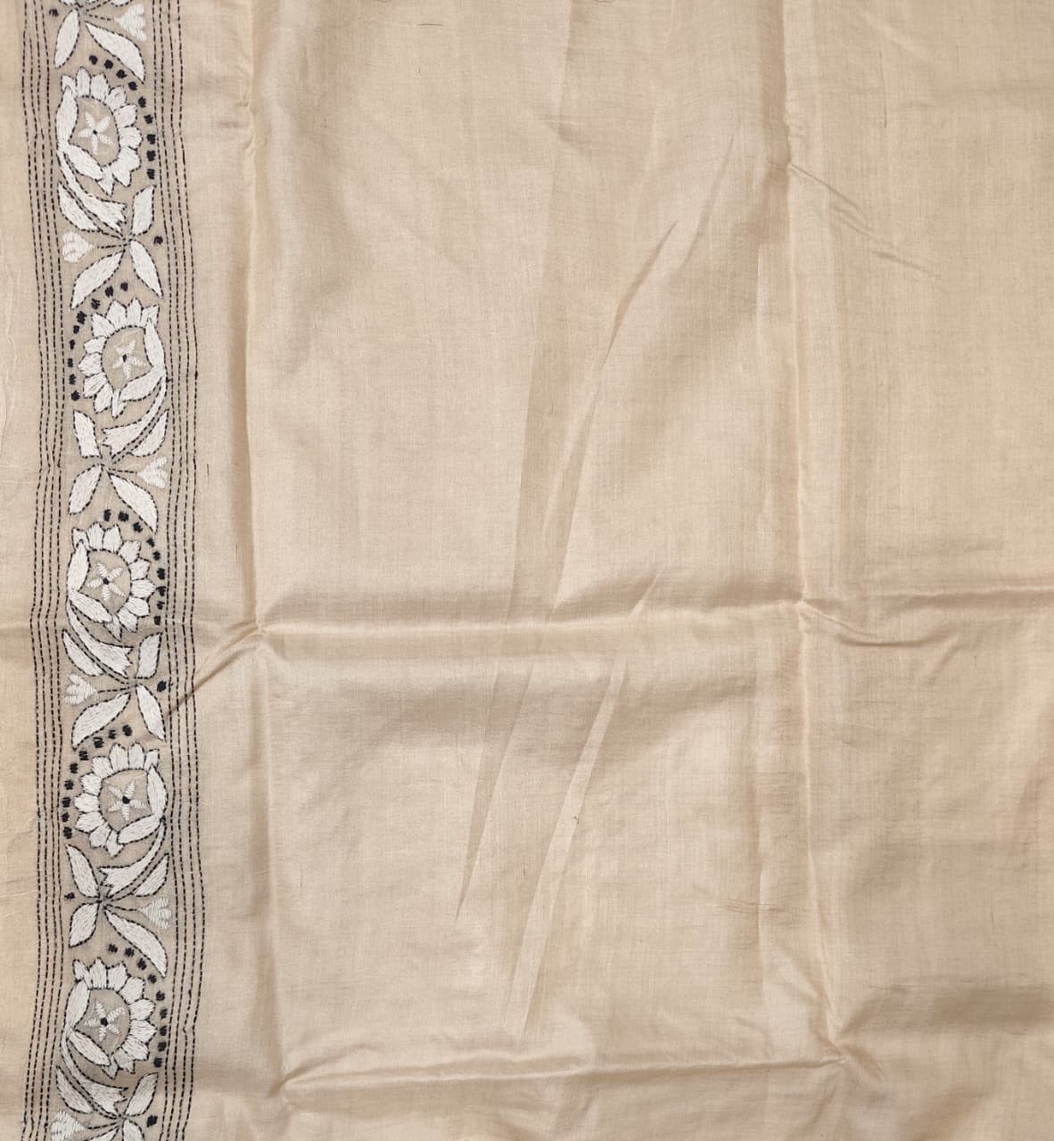 Beige Tussar embroidery saree with Kantha work border and unstitched blouse from Saarang Sarees, traditional wear with intricate detailing.