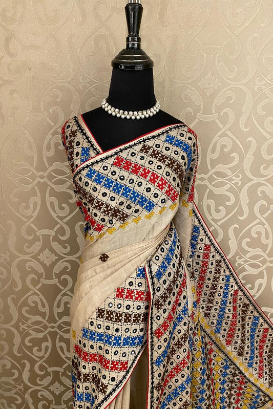 Beige Tussar Lambani and Kutch work saree with unstitched blouse, traditional Indian wear by Saarang Sarees.