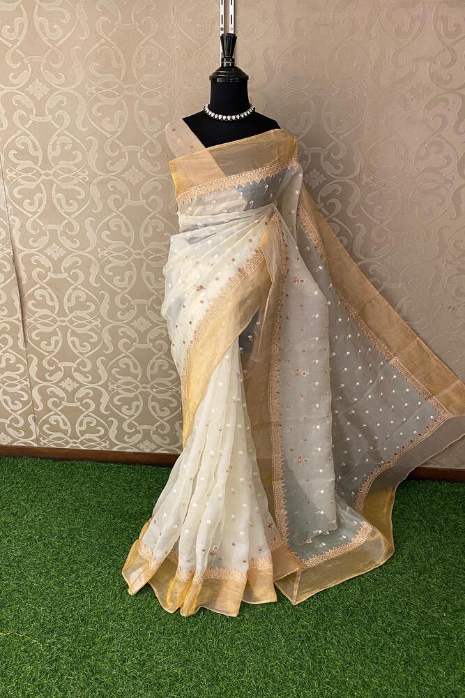 Off-White organza silk saree with intricate embroidery, paired with an unstiched blouse, perfect for party wear by Saarang Sarees.