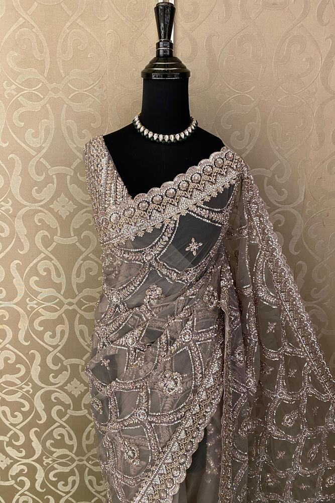 Grey party wear net embroidered saree with matching readymade blouse from Saarang Sarees, featuring intricate embroidery and elegant drape.