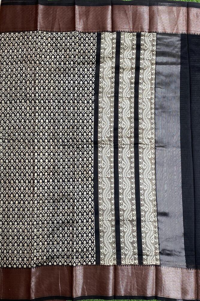 Black and white cotton Chanderi saree with traditional design and unstiched blouse, from Saarang Sarees, showcasing intricate fabric details.