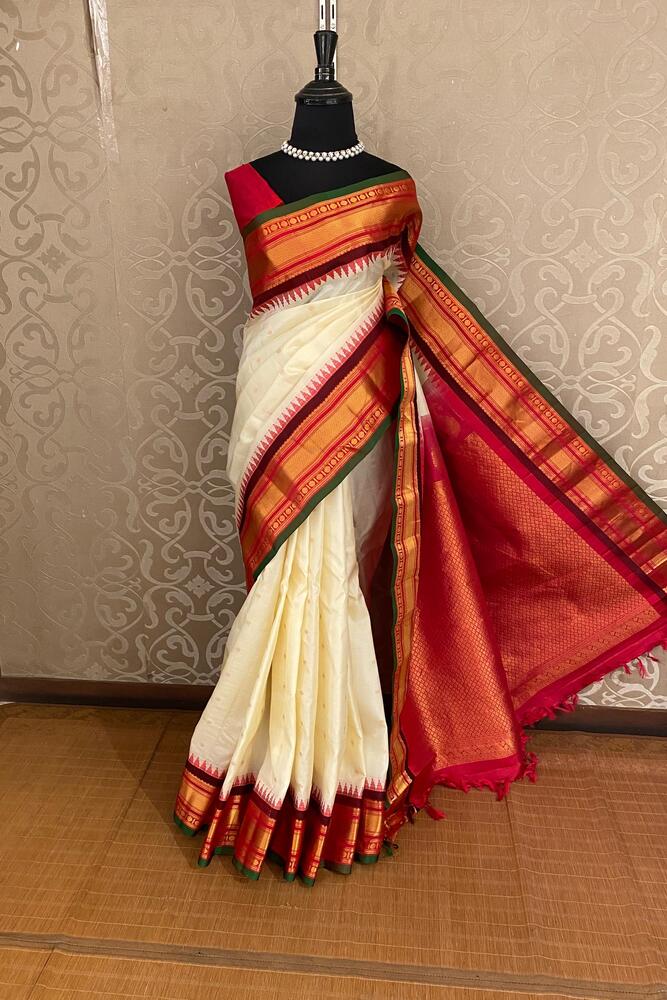 Off-White Gadwal silk saree from Saarang Sarees with intricate traditional design and an unstiched matching blouse.