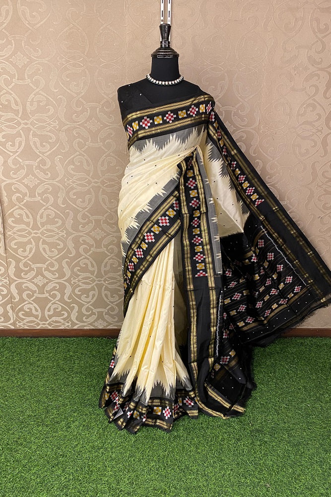 Off-White Pochampally Ikat silk saree with traditional patterns and an unstiched blouse, showcasing vibrant colors and intricate weaving.
