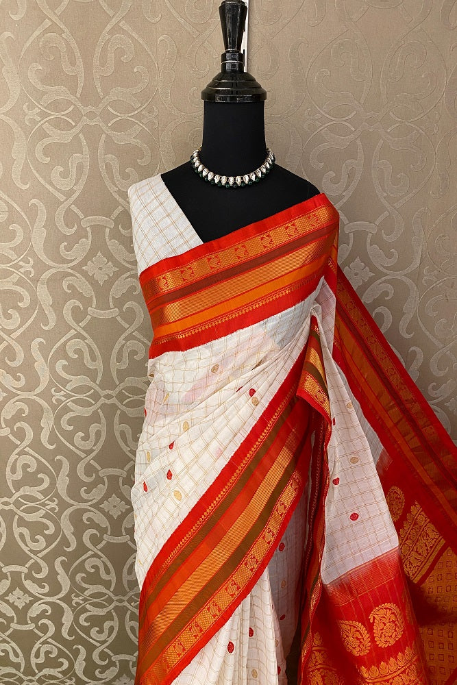 Off-White Sico Gadwal saree from Saarang Sarees with an unstiched blouse, showcasing intricate traditional Indian weaving and vibrant color.