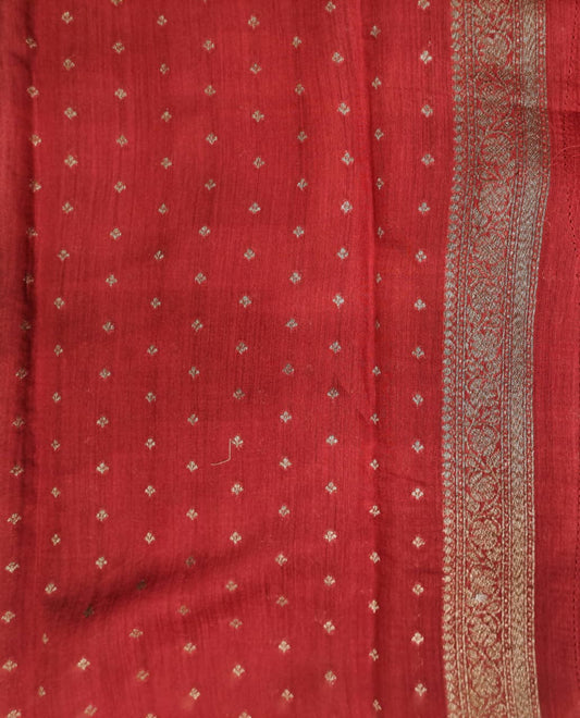 Deep green Munga Banarasi silk saree with intricate gold zari work, paired with an unstiched blouse for traditional wear.