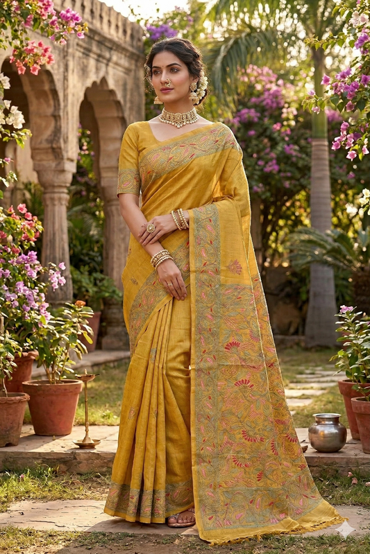 Mustard yellow Tussar saree with Lambani embroidery, traditional wear shown with unstitched blouse, by Saarang Sarees.