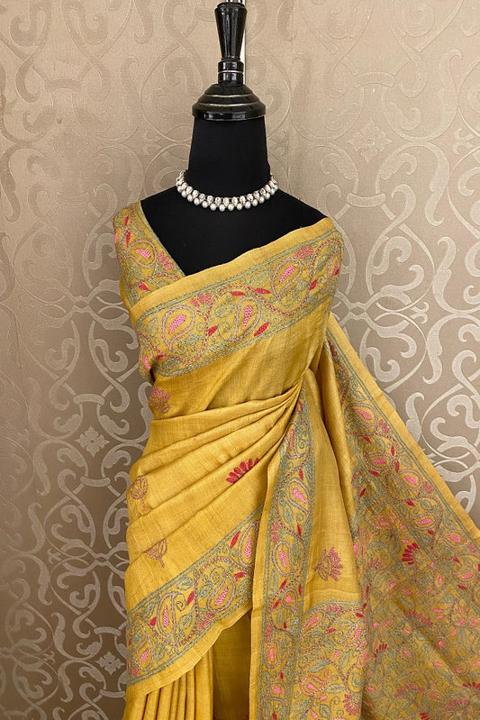 Mustard yellow Tussar saree with Lambani embroidery and unstitched blouse, traditional wear by Saarang Sarees.