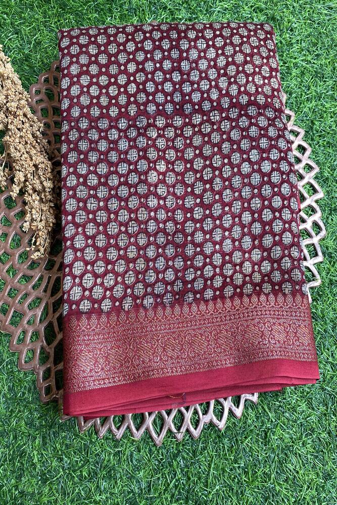 Maroon cotton Chanderi saree with intricate traditional patterns and an unstiched blouse, perfect for elegant traditional wear.