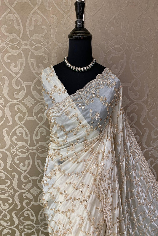 Off-White tissue organza silk saree with embroidery, paired with an unstiched blouse, ideal for party wear by Saarang Sarees.