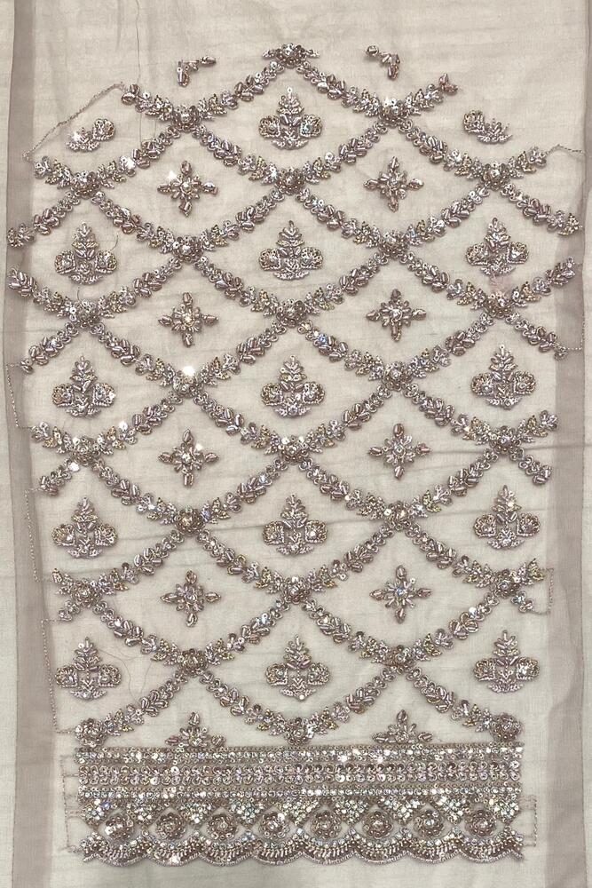 Grey party wear net embroidered saree with a matching readymade blouse, featuring intricate embroidery and elegant fabric details.