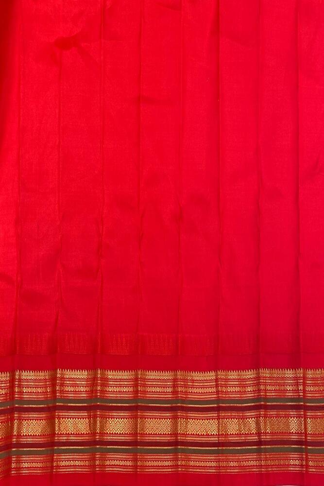 Off-White Gadwal silk saree by Saarang Sarees with intricate traditional design and matching unstiched blouse, displayed on a hanger.