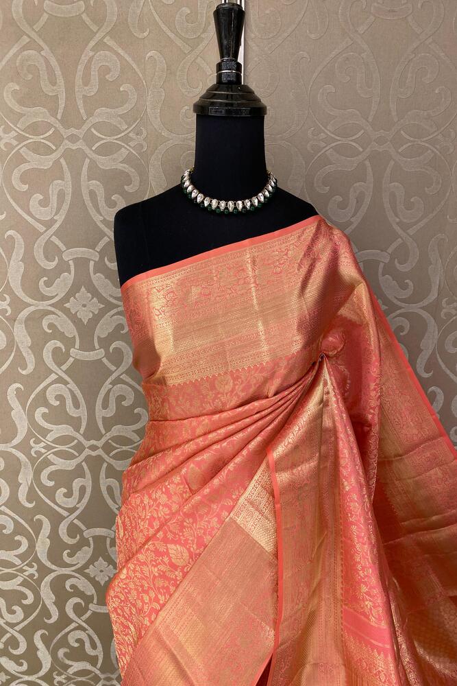Peach pink pure Kanjeevaram silk saree with traditional design and unstiched blouse from Saarang Sarees, displayed on a mannequin.
