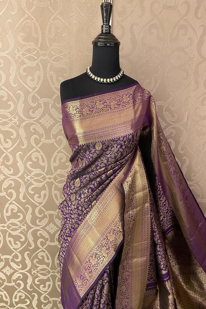 Deep violet Kanjeevaram silk saree with intricate gold zari work and matching unstiched blouse, traditional Indian wear from Saarang Sarees.