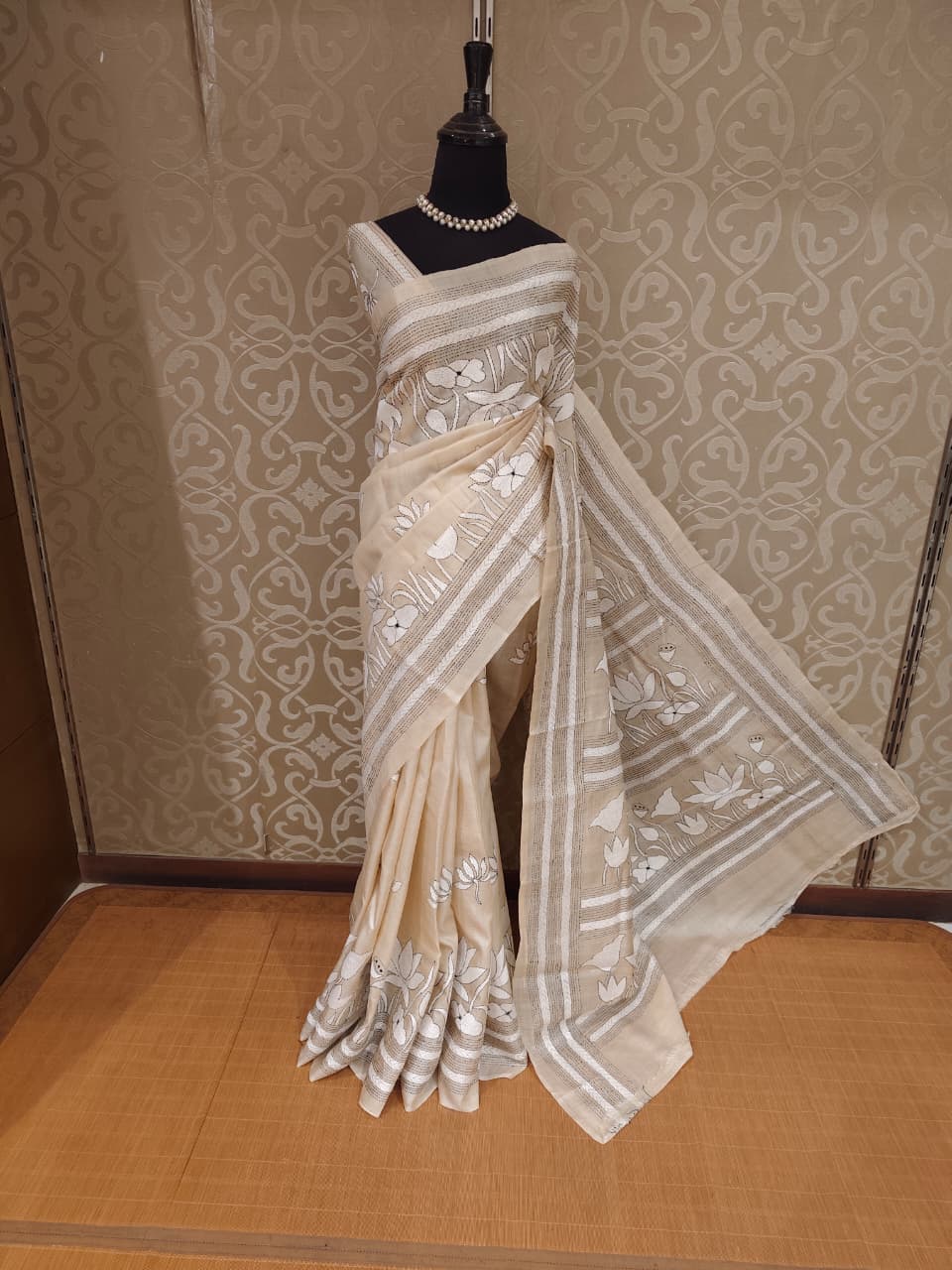 Beige Tussar embroidery saree with kantha work border and unstitched blouse from Saarang Sarees, traditional Indian attire.