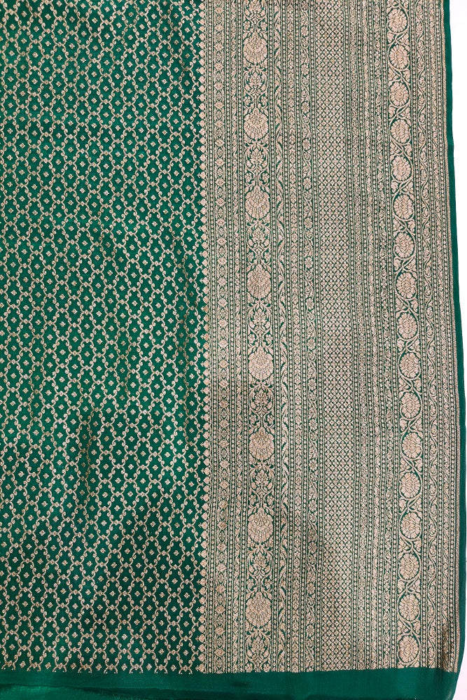 Yellow crepe Khaddi Banarasi silk saree with intricate gold patterns, traditional drape, paired with an unstiched blouse from Saarang Sarees.