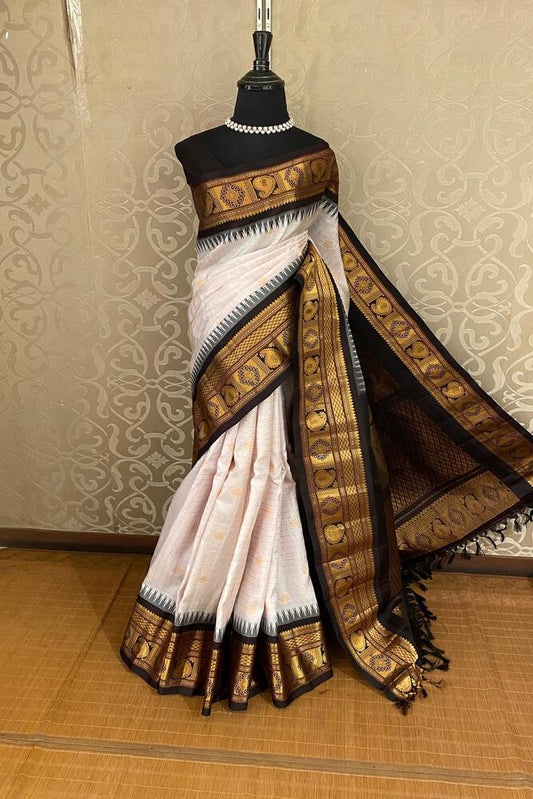 Off-White Gadwal silk saree with intricate traditional patterns and matching unstiched blouse from Saarang Sarees.