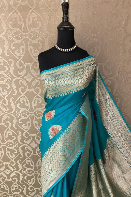 Teal blue Kora Banarasi silk saree with intricate hand weaving work and unstiched blouse, traditional wear from Saarang Sarees.