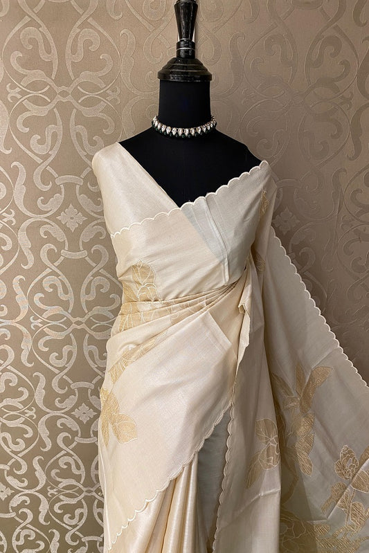 Off-White Tussar Saree with intricate applique work and matching unstiched blouse from Saarang Sarees, traditional wear.