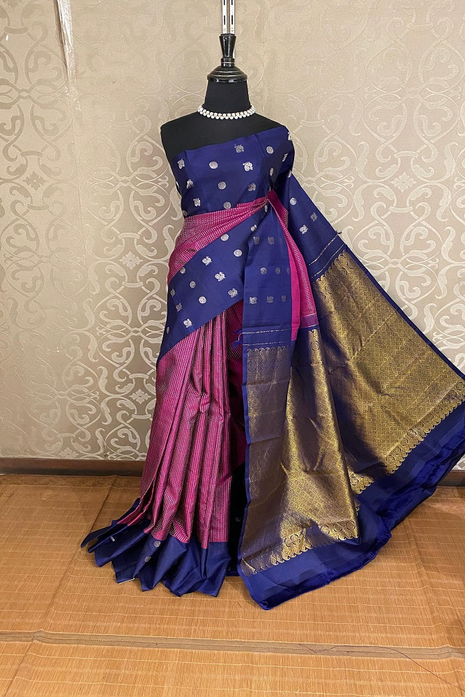 Navy blue pure Kanjeevaram silk saree from Saarang Sarees with intricate gold zari work and an unstiched matching blouse.