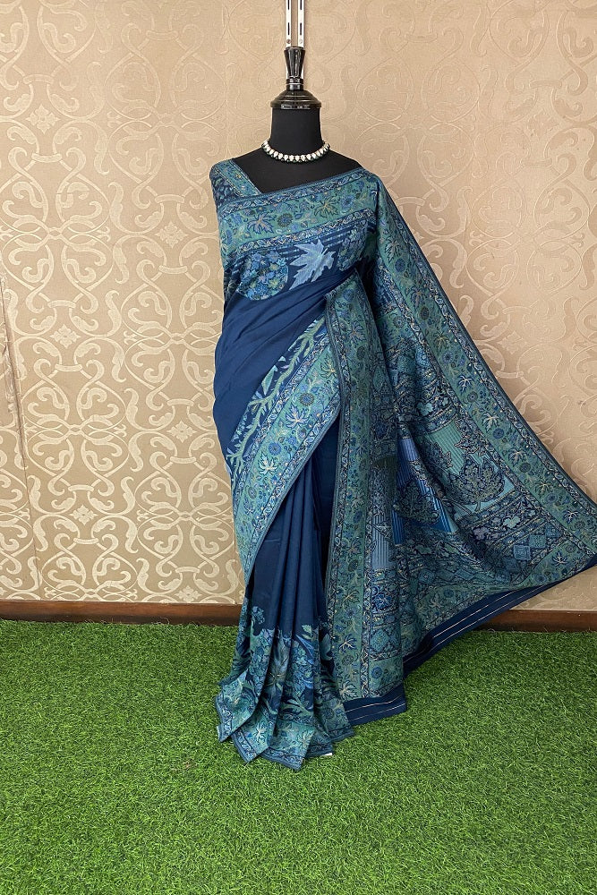 Navy blue pure Kani handloom silk saree with floral woven blouse, traditional wear by Saarang Sarees, displayed on a mannequin.