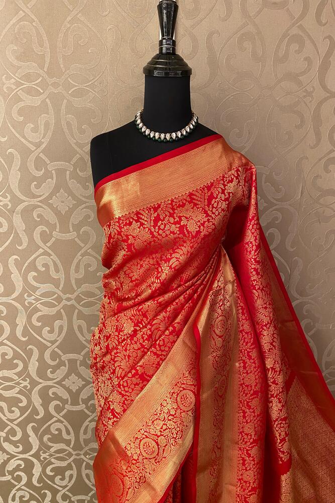 Red pure Kanjeevaram silk saree by Saarang Sarees with intricate traditional design and unstiched blouse for elegant wear.