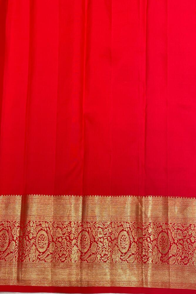 Red Pure Kanjeevaram silk saree from Saarang Sarees with traditional design and matching unstiched blouse, elegant and vibrant.