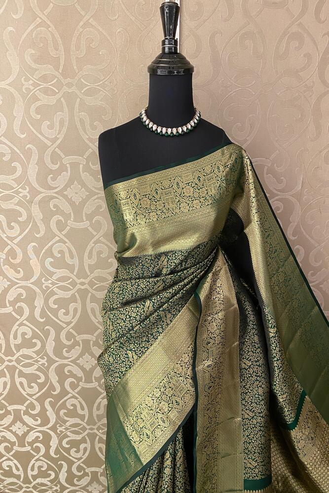 Forest green pure Kanjeevaram silk saree with intricate traditional patterns and matching unstiched blouse from Saarang Sarees.
