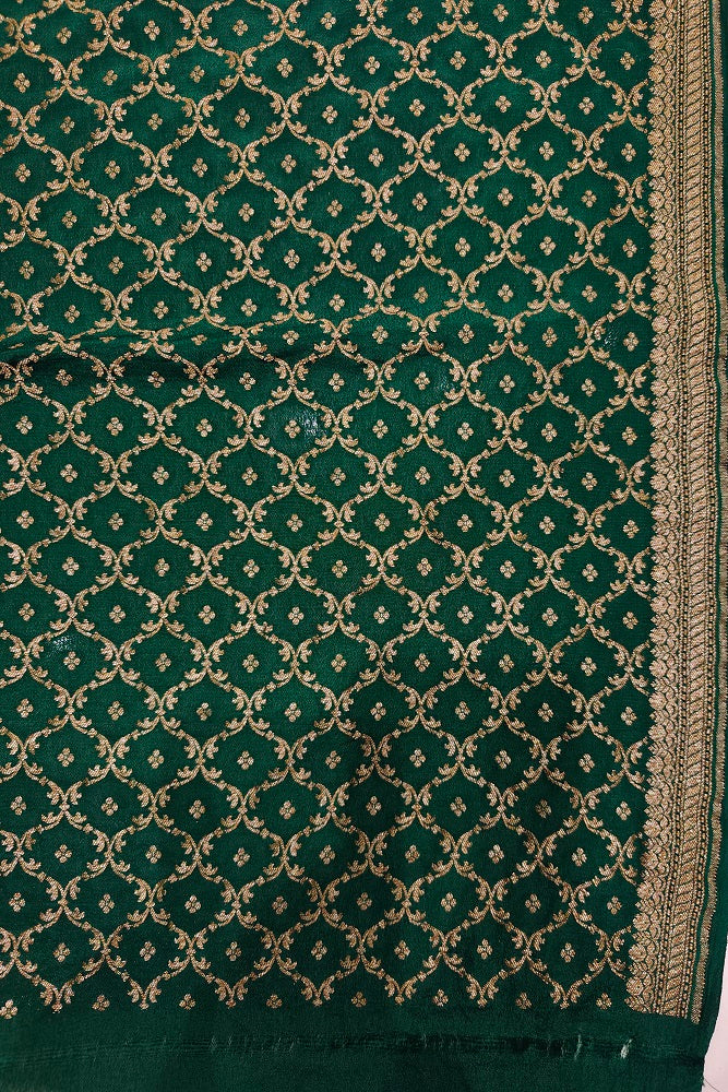 Pista green crepe Khaddi Banarasi silk saree with intricate gold zari work, paired with an unstiched matching blouse.