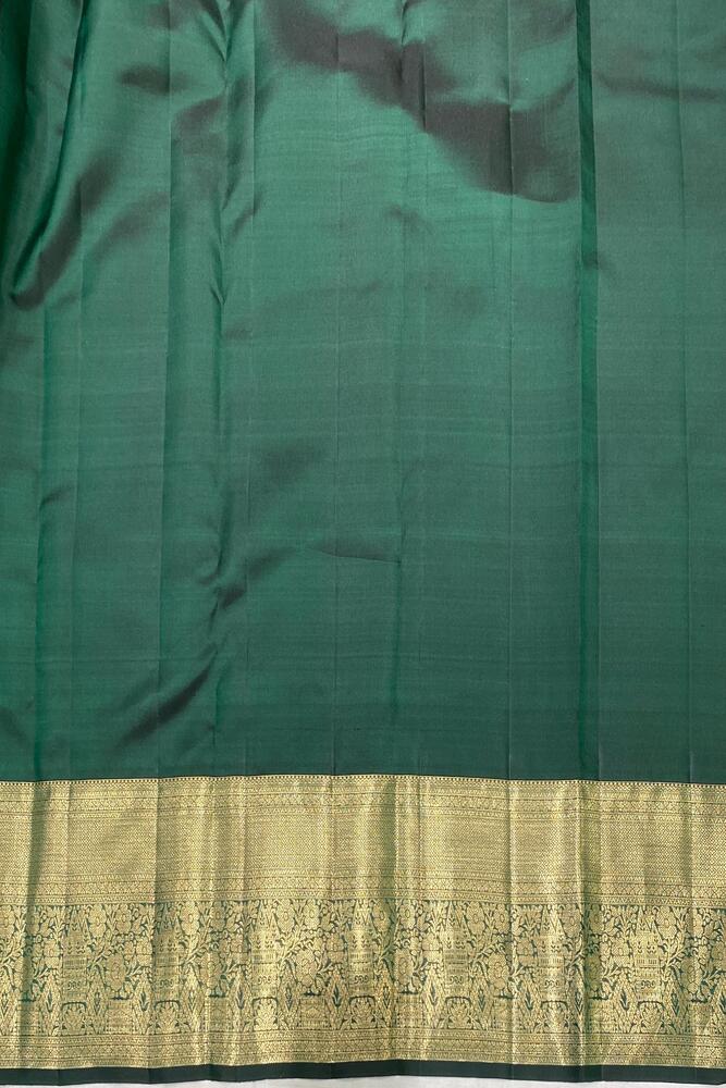 Forest green pure Kanjeevaram silk saree with traditional design and unstiched blouse, showcased by Saarang Sarees.