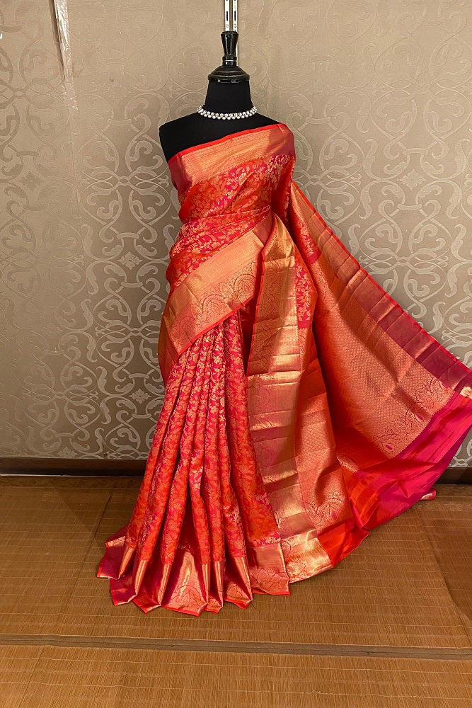 Cherry red Saarang Sarees Kanjeevaram silk saree with traditional design and matching unstiched blouse, showcasing rich fabric and intricate patterns.