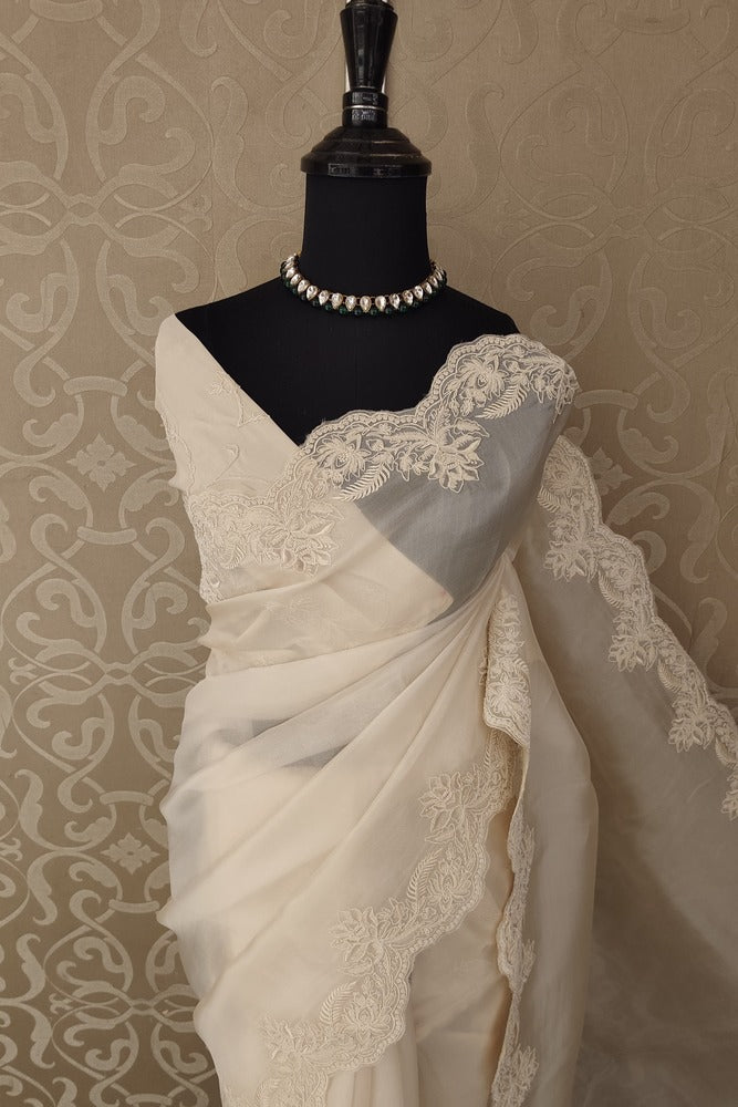 Off-White organza silk saree with resham embroidery, party wear design, paired with an unstiched blouse by Saarang Sarees.